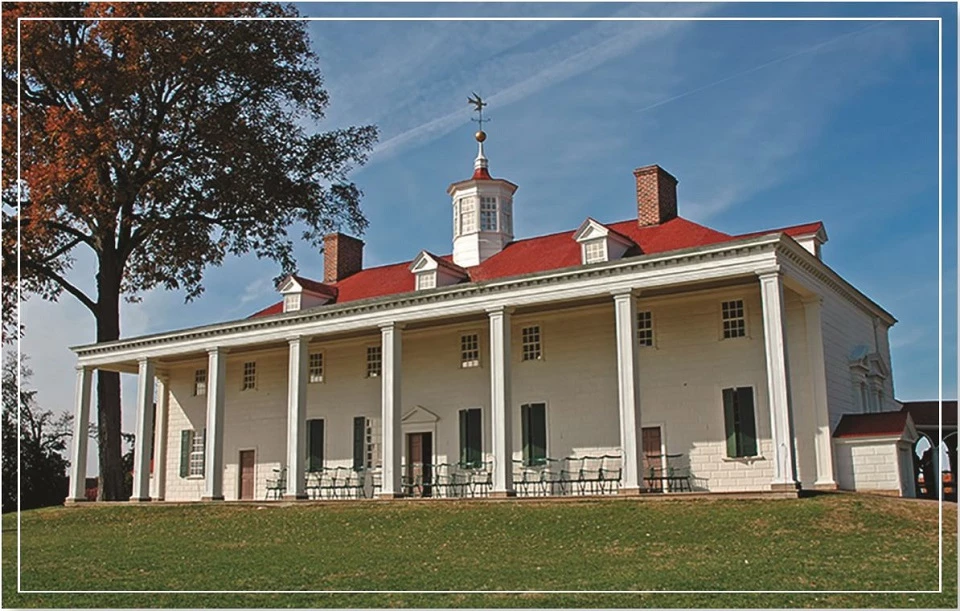 historic colonial-style house with a large porch and green lawn